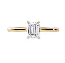 14k yellow gold solitaire style engagement ring featuring a lab created 1.05ct emerald cut diamon…